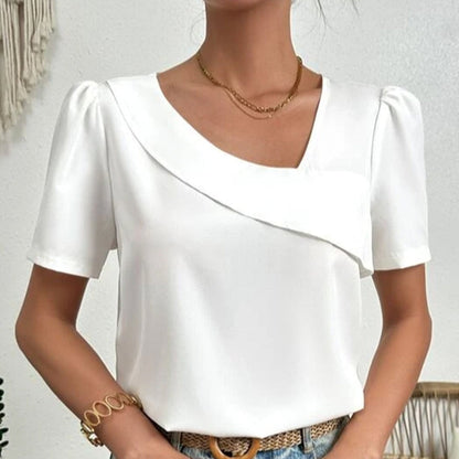 Blouse blanche asymétrique avec manches bouffantes et col